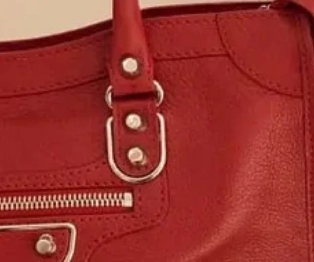 To authenticate a Balenciaga handbag, check Notched Rivets