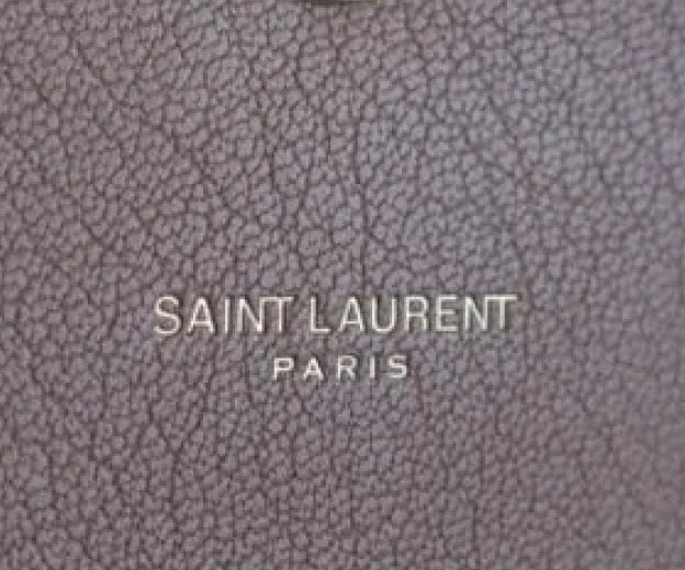 To authenticate a Saint Laurent bag look for Uniform font-weight on “SAINT LAURENT PARIS” engraving