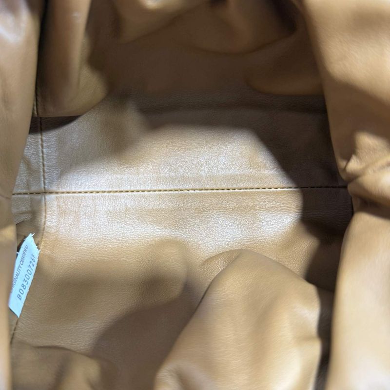Bottega Veneta ORIGINALITY CERTIFIED tag sewn into a bag lining, with the serial number printed beneath the words